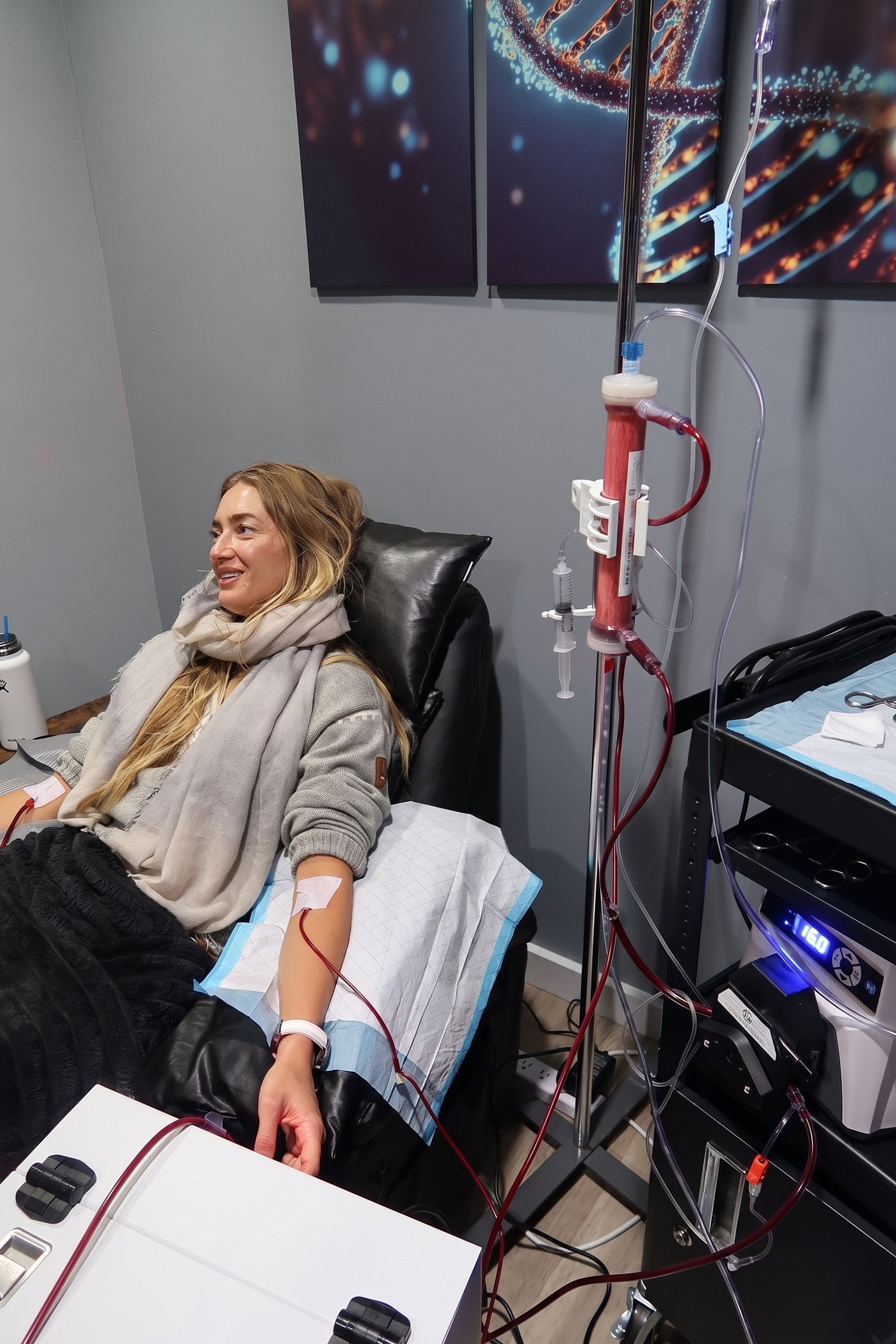 A client relaxing and smiling mid session in the treatment chair